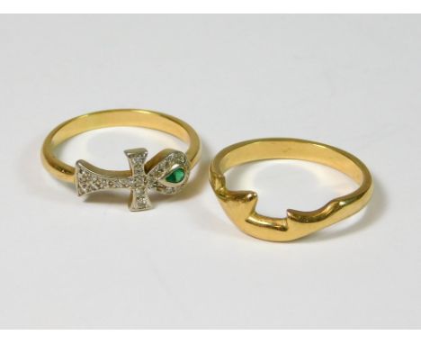 STACKING RINGS. A duo of yellow metal stacking rings, comprising an emerald & diamond set Ankh ring & a plain band, unstamped