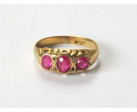 VICTORIAN RING. A Victorian ring, set with two oval & one round synthetic pink stones, with three (of four)small diamonds. Si