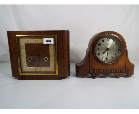 An oak cased art deco mantle clock by Smiths striking on the hour and half-hour, Arabic numerals with pendulum and key and a 