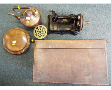 A lot to include a vintage sewing machine in wooden case, a copper kettle and a bed warmer