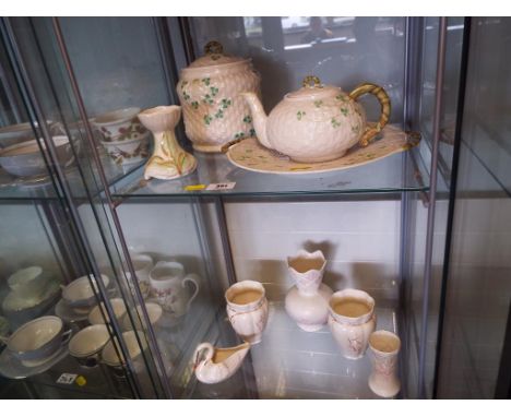 Belleek - a collection of eleven pieces of ceramics by Belleek to include a pair of vases, teapot, biscuit barrel and other (