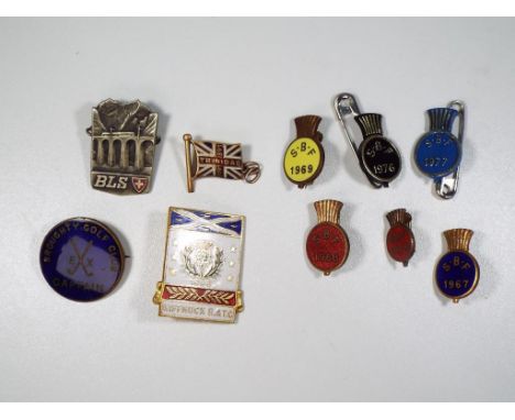 A collection of vintage enamel lapel badges and pin badges