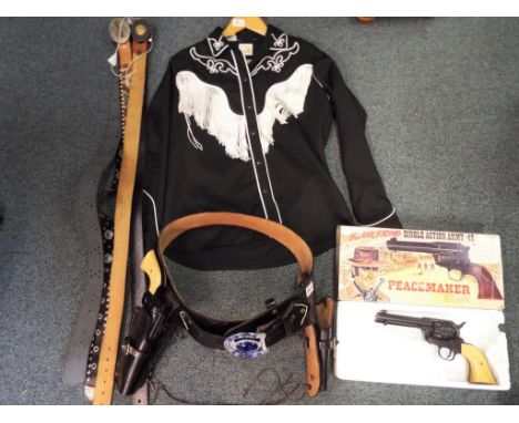 A leather 2 gun holster belt, 5 leather belts and 2 replica single action army .45 'Peacemaker' revolvers and a country and w