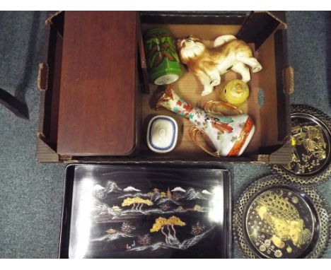 A good mixed lot to include a small wooden cabinet, a tray with oriental decoration, 2 pierced metal pieces of wall art, a li