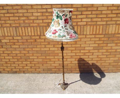 A metal floor standing lamp with floral decoration shade also includes 2 Asian carvings one of a Buddha and one of a tower