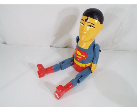 A carved hand-painted Superman shelf puppet. Estimate £20 - £30