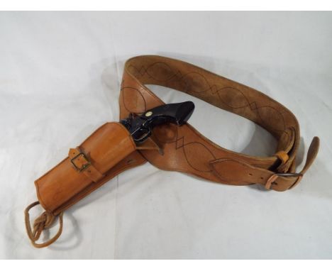 A replica pistol marked Sussex Armoury and single action army .45 with leather gun belt and holster