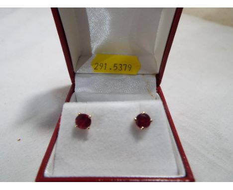 A pair of 9ct gold and ruby earrings, 5mm diameter, boxed Est £50 - £80