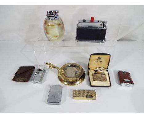 A collection of vintage cigarette lighters and table lighters