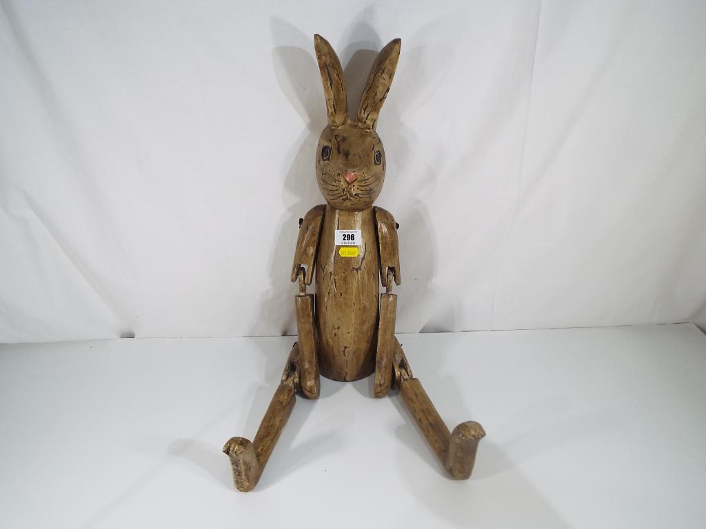 A carved wooden shelf rabbit with jointed limbs Est £20 £40