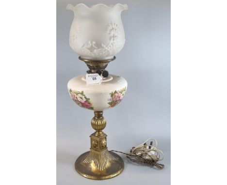 20th century oil burner now converted to electricity with frosted glass shade on a ceramic floral reservoir and brass base.  
