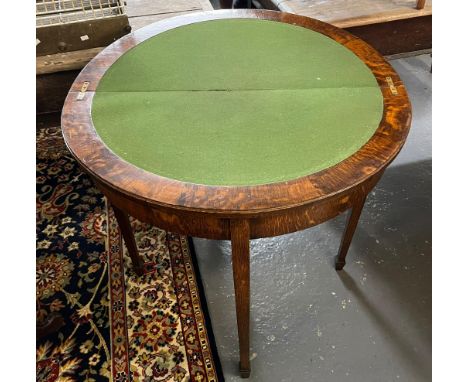 Early 20th century oak demilune folding card table on square tapering legs and spade feet.   (B.P. 21% + VAT) 