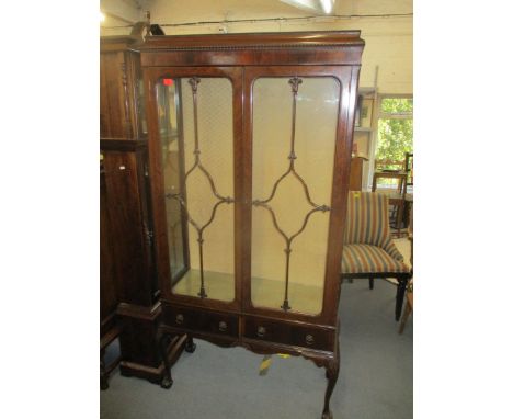 An early 20th century mahogany Chippendale style display cabinet, twin glazed doors above two short base drawers, on leaf kne