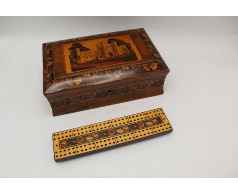 A 19th century Tunbridge ware walnut games/cribbage box, the hinged lid decorated with a castle within a band of leaves, encl