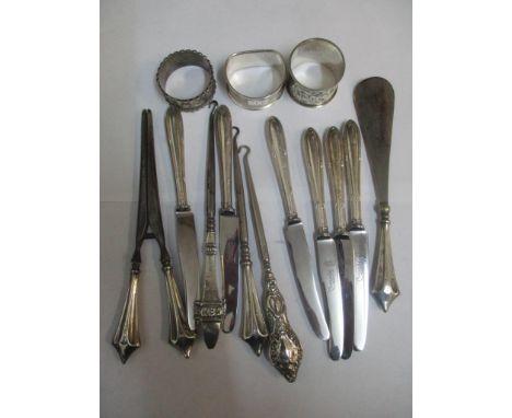 Silver handled knives, two silver handled button hooks, three silver napkin rings and a set of three silver handled glove str