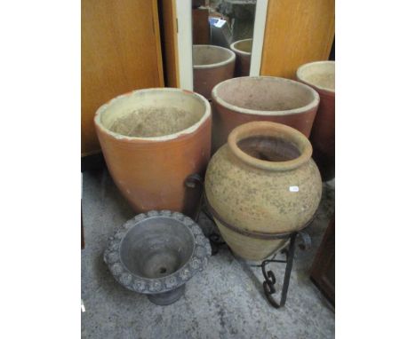 Mixed garden planters to include a terracotta planter of tapered form in an iron baseLocation: 