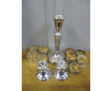 Silver to include a pair of dwarf candlesticks, a weighted candlestick, five napkin rings and a set of four silver plated nap