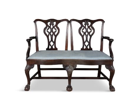 AN IRISH MAHOGANY DOUBLE-CHAIR BACK SETTEE, 19TH CENTURY, the openwork back, with twin intertwined splat, upholstered drop-in