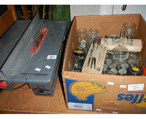 A circular bench saw and a box of screws etc.,