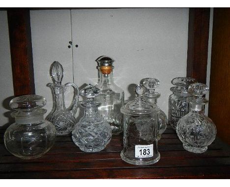 A mixed lot of cut glass liquor/perfume decanter, jars etc.,