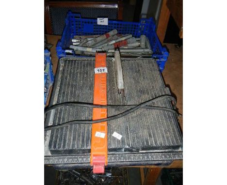 A small bench saw and a box of socket spanners.