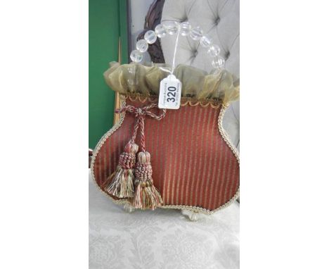 A handbag shaped lamp shade.