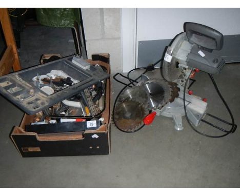 A bench saw and a box of tools etc.