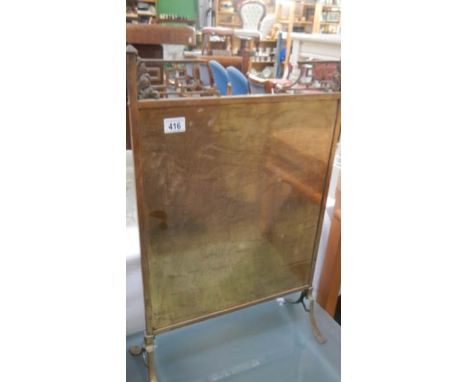 A brass fire screen.