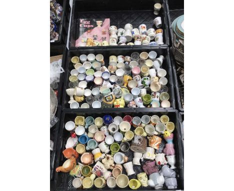 A large collection of Briish and European ceramic and glass egg cups, including Doulton Bunnykins, Sooty, Noddy etc, S S Gard