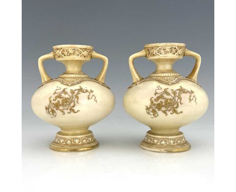 A pair of Royal Worcester twin handled vases, ovoid footed form, date code 1886, ivory gorund with raised floral and foliate 