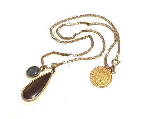 A 9ct gold flat link chain, suspending a 9ct gold medallion, a 9ct gold opal triplet pendant and a yellow metal enamel pendan