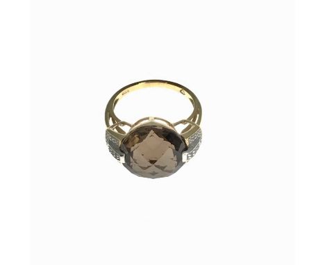 A 9ct gold smoky quartz ring, diamond set shoulders