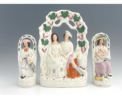 A Staffordshire arboreal figure group, circa 1870, figures glazed white with polychrome enamel and gilt-painted details, the 