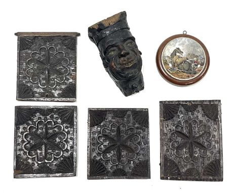 An antique carved oak gargoyle mask capital of a grinning man, 17cm high, four 17th Century carved oak panel inserts, and a 1