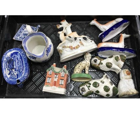 Collection of Staffordshire ceramics including a house money box, flatback spill vase, dog hunting a stag, a pair of greyhoun