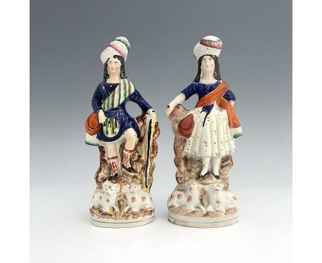 A pair of Staffordshire shepherd and shepherdess figures in Scottish Highland dress, circa 1850, Scottish shepherd figure hol