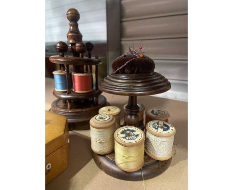 Two treen bobbin holders, a Mauchline ware ladle, a Mauchline ware reel box with all thread guides intact, and a ring tree (5