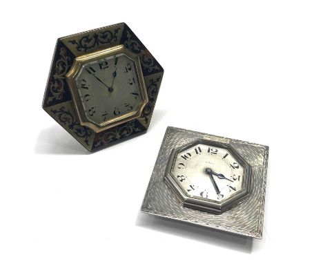 Two Art Deco desk clocks, one with faux boulle decoration, octagonal form with silvered dial, the other with silver engine tu
