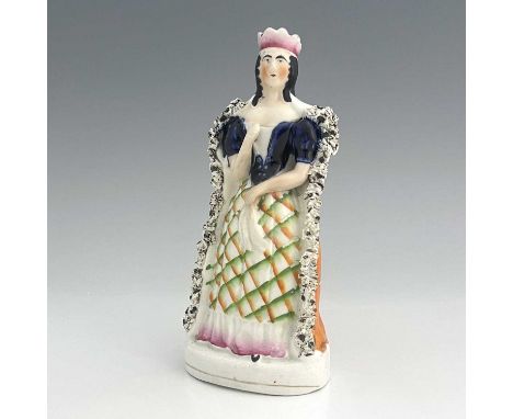 A Staffordshire figure of Sarah Siddons as Lady Macbeth, circa 1850, modelled as a Queen in textured ermine robe and pink gla