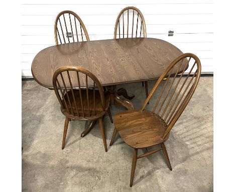 An Ercol Golden Dawn Chester extending dining table, extending top with hidden leaf, on pedestal base, on four down swept leg