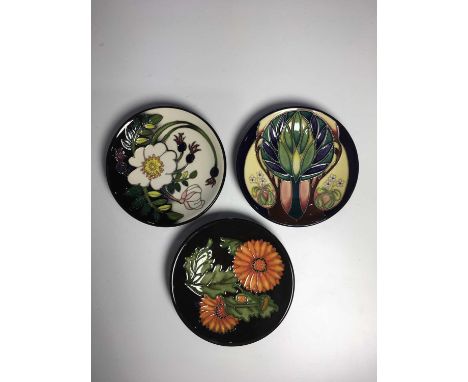 Three Moorcroft coasters, including Japanese Chrysanthemum circa 2009, RHS Scotch Rose Coaster by Nicola Slaney circa 2016 an