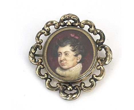 A 19th Century oval portrait brooch, bust of a gentleman wearing a ruff, on ivory, in a yellow metal open-scrollwork mount, 2