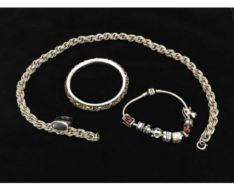 A selection of silver jewellery, including a heavy ropetwist necklace, a bangle with linked inset band, a black onyx set ring