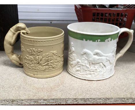 A stoneware saltglazed hunting mug, with relief moulded hunting scene and coursing hound handle, together with a similar exam