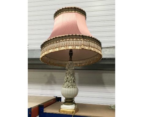 A white glazed French style lamp base, baluster form, the upper section with floral encrustations, the reeded globular base o