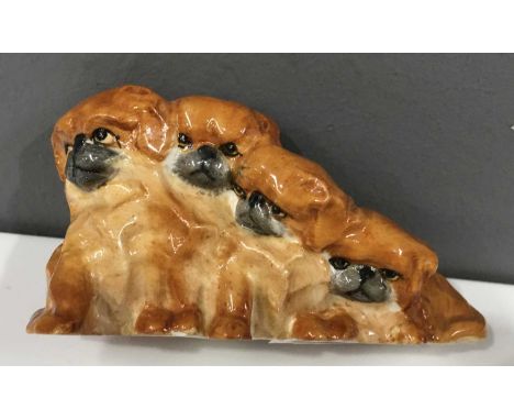 Dors Lindner for Royal Worcester, a figure group modelled as four seated Pekinese, shape No.3118, 19cm wide