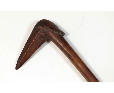 A 19th Century Kanak, New Caledonia Bird-Headed Club, in a light brown smoothly patinated hard wood, the cylindrical haft wit