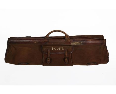 An Early 20th Century Military Officer's Suit Carrier, in brown canvas trimmed with crushed leather, with rolled leather hand