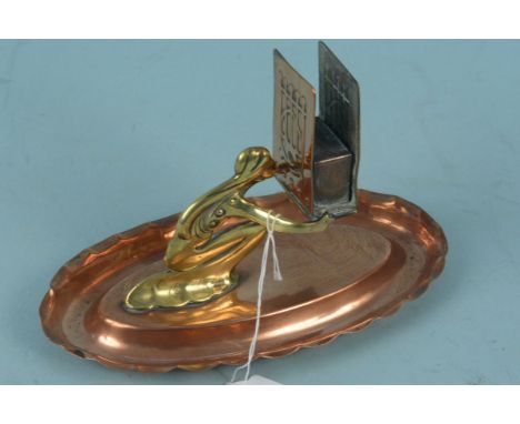 An Art Nouveau period copper and brass figural matchbox holder, 18.5cm long