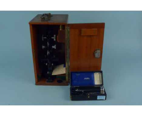 A boxed vintage school laboratory room microscope by Cooper Troughton &amp; Simms plus 'The Keeler Ophthalmoscope' in origina